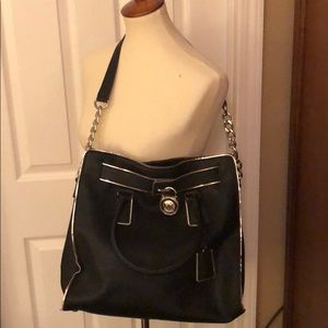 Michael Kors Black handbag with silver trim.